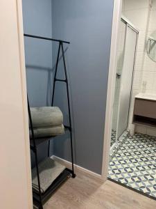 a bathroom with a towel rack next to a shower at departamento leon gallo (e) in Temuco