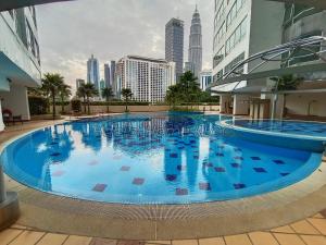 a large swimming pool in the middle of a city at Habibi HoMe KLCC in Kuala Lumpur