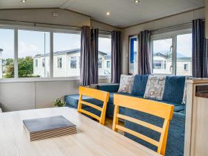 a living room with a couch and a table and chairs at Merse Place 4 - Uk45159 in Mainsriddle