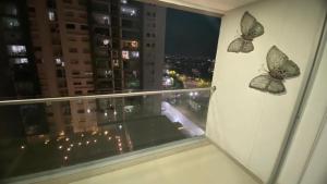 two butterflies on the side of a window with a city at Habitacion Ciudadela Nio 1 in Neiva