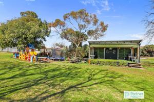 a park with a playground and a building at The Oasis Tamworth in Tamworth