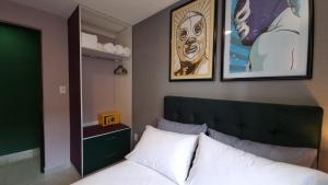 a bedroom with a bed and some pictures on the wall at Departamento Completo Frente al Aeropuerto in Mexico City +17 photos