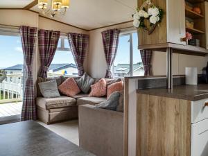 a kitchen and living room with a couch and windows at Sea View 14 - Uk45161 in Mainsriddle