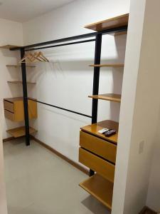 a room with a closet with wooden shelves at Amazonia Deluxe Lake Condo in Leticia