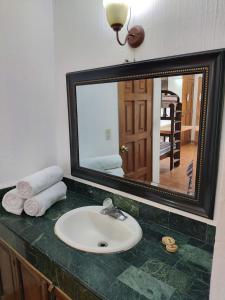 a bathroom with a sink and a mirror on a counter at Perla Maya Hotel in Panajachel