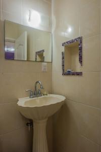 a bathroom with a sink and a mirror at Marysol d10 private beach next to nomads in Isla Mujeres +20 photos