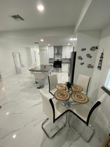 a kitchen with a table and chairs in a room at Mango Tree House in Lake Worth