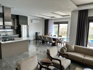 cocina y sala de estar con sofá y mesa en Modern Luxury Villa, en Antalya