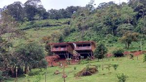 a house on the side of a hill at Bungalows Paraíso Celeste in Bijagua