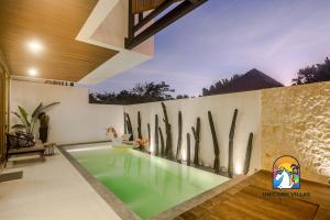 a swimming pool in the middle of a house at Villa Rufina - by Unicorn Villas Bali in Canggu