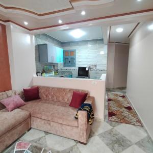 un salon avec un canapé et une cuisine dans l'établissement Spacious and Luxury Family Apartment Full Pyramids view, au Caire 14 autres photos