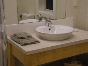 a bathroom with a white sink and a mirror at Seatonwood Villas in Swannanoa