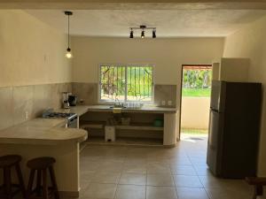 a kitchen with a counter and a sink and a refrigerator at Los Amores Apartments C in Pérula