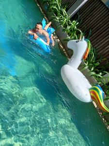 Sun Paradise Villa Hoi An في هوي ان: صبي صغير في الماء على زحليقة مائية