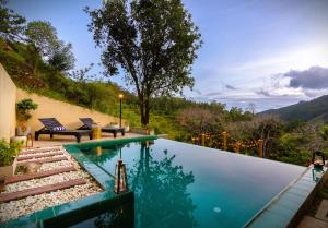 a swimming pool with a view of the mountains at The Capoe House in Haputale