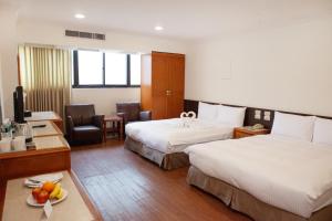 Voodi või voodid majutusasutuse YUAI FU HAO Hotel toas
