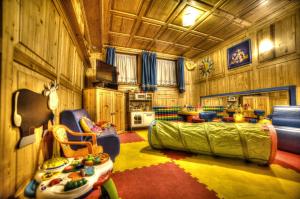 a room with a bed and chairs in a house at Albergo Venezia in Sappada