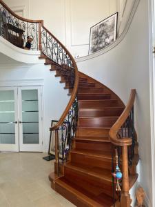 a staircase with wooden treads and wrought iron railings at Lucky room, A comfortable suite close to YVR Richmond in Richmond