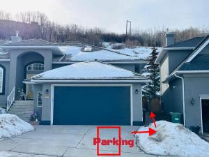 a house with a garage with a red arrow saying parking at 2 Bedrooms Private Basement Suite Close to Winsport & Downtown in Calgary