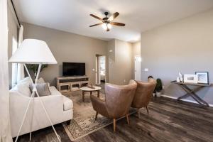 a living room with a couch and a ceiling fan at NEW! Beautiful and Spacious Home in Ozark