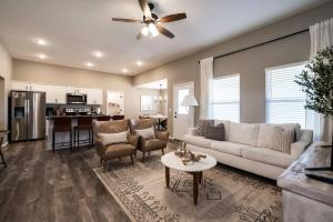 a living room with a white couch and a table at NEW! Beautiful and Spacious Home in Ozark