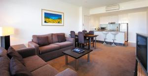 a living room with a couch and a table at Club Wyndham Lakes Entrance in Lakes Entrance