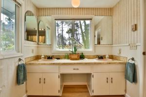 a bathroom with two sinks and a window at Sandpiper Shores in Florence