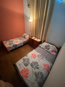two beds in a room with a lamp on a table at Ferme Paradiso, Route de Jerada, Sidi Moussa Lemhaya, Oujda in Oujda +25 photos