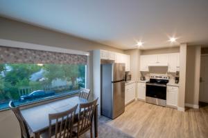 a kitchen with a table and a large window at Scott's Inn & Suites in Kamloops