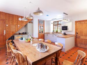 a kitchen and dining room with a wooden table and chairs at Crablake Farmhouse in Exeter