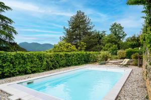 a swimming pool in the yard of a house at La Maison Jaffran, suite en ville in Privas