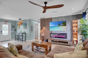 a living room with a large flat screen tv at Casa Blue Pelican. in Marathon
