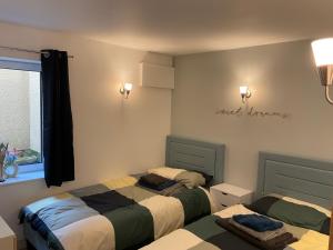 a bedroom with two beds and a window at Millside in Stroud