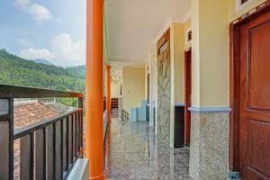 a balcony with a door and a view at OYO Life 90321 Ken Ken Villa in Batu