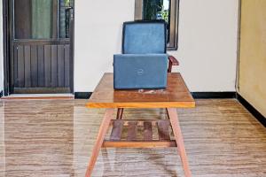 a desk with a blue briefcase sitting on top of it at OYO Life 92353 Purnama Syariah Guest House in Blitar