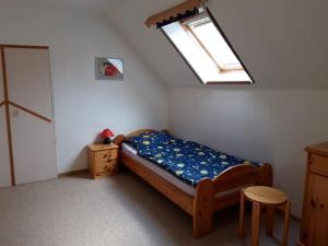 a small bedroom with a bed and a skylight at Haus Marie in Krummhörn