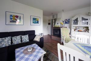 a living room with a couch and a table at Haus Achter de Kark in Krummhörn