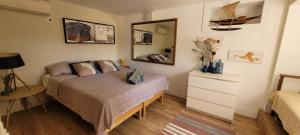 a bedroom with a bed and a mirror at Le Repaire de la Cadière à 5mn des plages ! in Saint-Cyr-sur-Mer