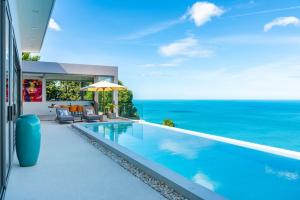 a swimming pool with a view of the ocean at Villa CholChalee - Amazing View in Amphoe Koksamui