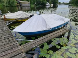 two boats are docked next to a dock at Ferienhaus Elbe -Parey am See in Parey +8 photos