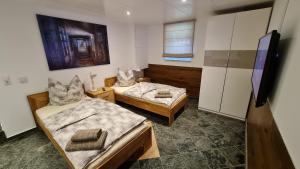 Zimmer mit 2 Betten und einem TV. in der Unterkunft Handwerkerwohnung-Monteurunterkunft in Darmstadt