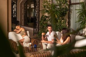 a group of people sitting on a couch at Jaz Oriental, Almaza Bay in Marsa Matruh