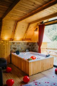 a large wooden room with a tub in a house at Serinle Bungalow in Rize