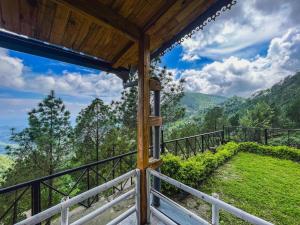 a view from the porch of a mountain house at Mountain View Resort Nainital in Nainital