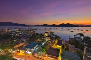 an aerial view of a city at night at Sunburn Suites and Rooftop Bar in Coron