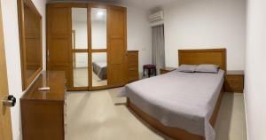 a bedroom with a bed and a mirror at Queen plaza Nasr City in Cairo