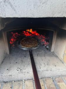 a pizza is cooking in a brick oven at DaVi' casa vacanze. Un sogno immerso nel verde ! in Montepagano