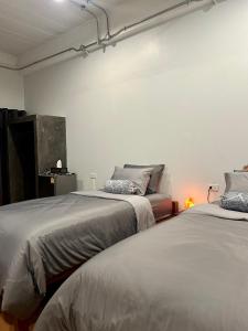 two beds sitting next to each other in a room at Chern Chiangmai Boutique Hotel in Chiang Mai