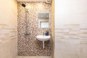 a bathroom with a sink and a shower at Modern 1BR Apartment with Private Garden Top Center in Plovdiv