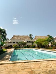 een zwembad voor een huis bij 611 Sporting Residence in Malindi